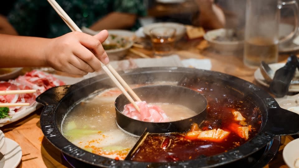 Hot pot can involve a range of meats and veggies cooked in a bubbling, spicy broth. - yuriygolub/Adobe Stock