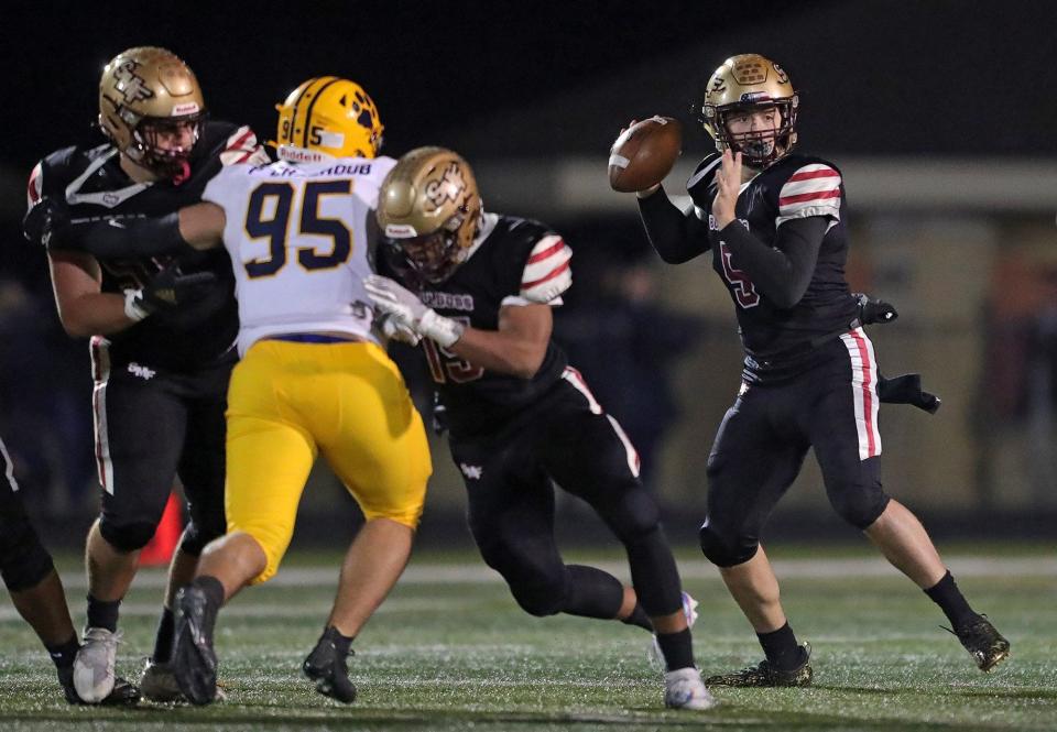 Stow quarterback Nate Boozer looks to pass during the first half of a Division I playoff football game against St. Ignatius, Friday, Nov. 5, 2021, in Stow, Ohio. [Jeff Lange/Beacon Journal]