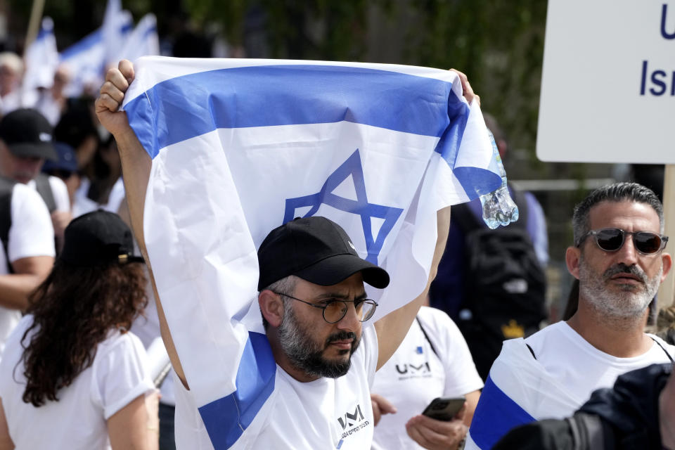 A man holds Israel's flag at the former Nazi German death camp of Auschwitz-Birkenau during the annual Holocaust remembrance event, the "March of the Living" in memory of the six million Holocaust victims in Oswiecim, Poland, Monday, May 6, 2024. The event comes amid the dramatic backdrop of the violence of the Israel-Hamas war after the Oct. 7 Hamas attack, the deadliest violence against Jews since the Holocaust, and as pro-Palestinian protests sweep U.S. campuses. (AP Photo/Czarek Sokolowski)