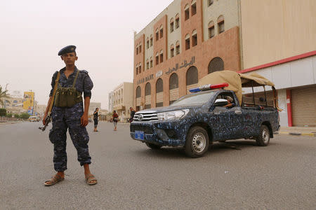 A pro-Houthi police trooper stands past a patrol vehicle in the Red Sea port city of Hodeidah, Yemen June 14, 2018. REUTERS/Abduljabbar Zeyad