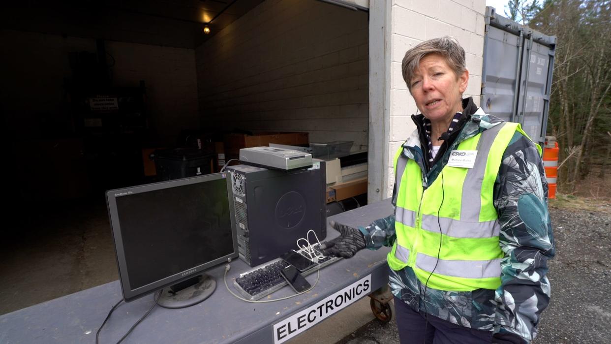 Michele Morris of Chittenden Solid Waste District stands next to a pile of electronic waste ("e-waste") at CSWD's Williston drop-off center. E-waste cannot go in the trash or the blue recycling bin in Vermont. It can be brought to CSWD drop-off centers.