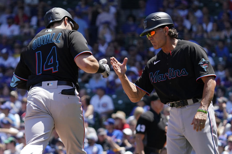 Miami Marlins' Adam Duvall celebrates with third base coach Trey Hillman as he rounds the bases after hitting a two-run home run during the first inning of a baseball game against the Chicago Cubs in Chicago, Saturday, June 19, 2021. (AP Photo/Nam Y. Huh)