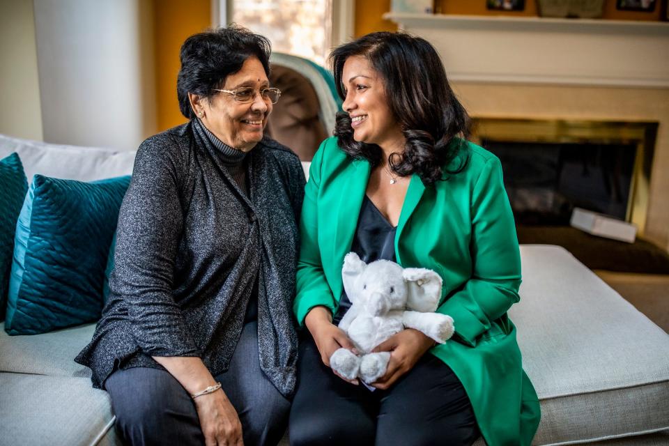 Sveta Prakash Desai, 40, sits on the couch with her mother Geeta Prakash Desai, 73, who will help her raise the baby she is having by surrogate at their home in Troy, Mich., on Nov. 16, 2023. Sveta has breast cancer and is currently in remission. She wanted to have a child after completing cancer treatment, but her body didn't cooperate. After five failed eggs following a retrieval (before her diagnosis) and an aggressive cancer, Sveta is now expecting a baby via surrogate this March.