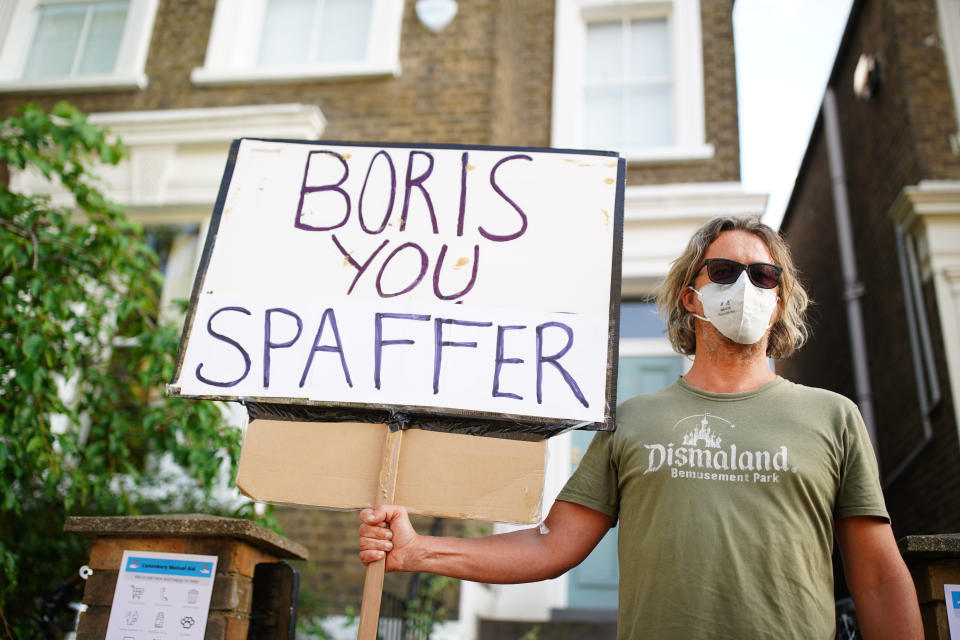 A protester outside the north London home of Prime Minister Boris Johnson's senior aide Dominic Cummings after he gave a press conference over allegations he breached coronavirus lockdown restrictions. (Photo by Aaron Chown/PA Images via Getty Images)