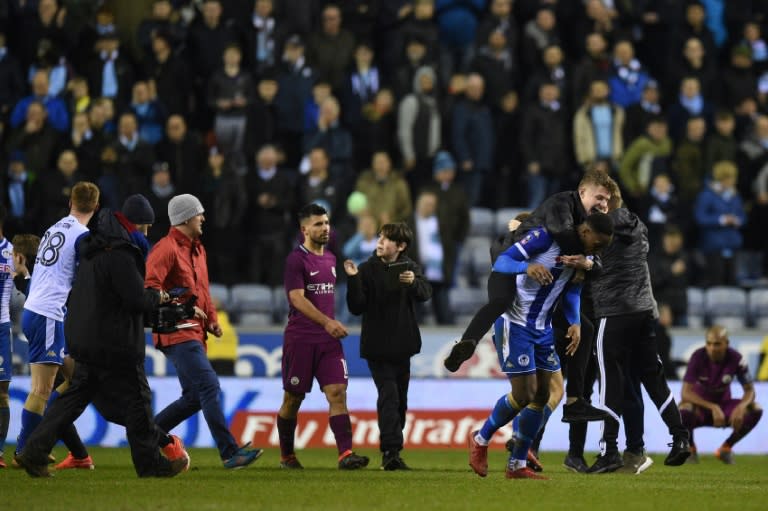 Fans invaded the pitch after Wigan's victory and Manchester City striker Sergio Aguero eventually lost his temper