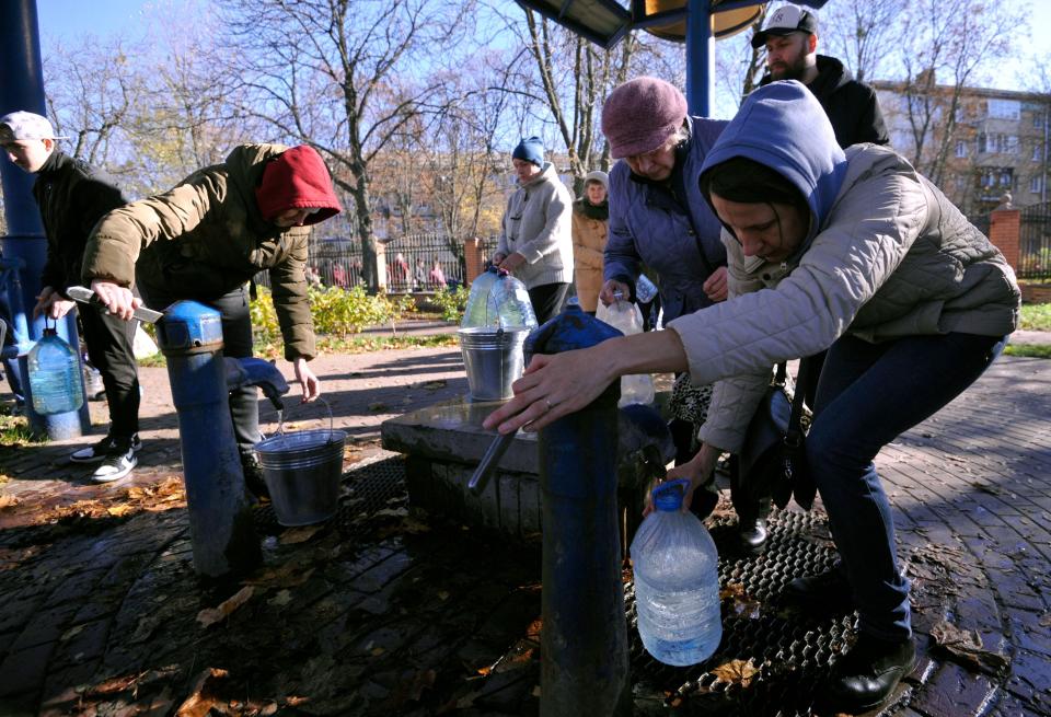 Residents queue to collect water in plastic containers and bottles at one of the parks in the Ukrainian capital Kyiv on Monday.