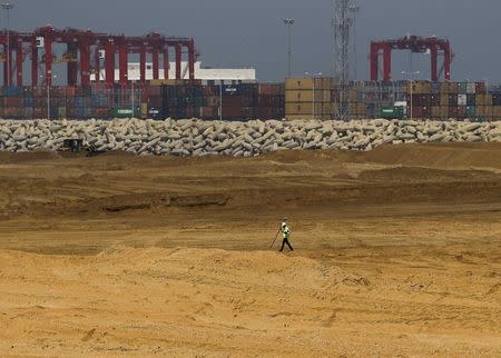 An engineer walks through a part of a construction site of Chinese investment "Colombo Port City" in Colombo February 20, 2015. REUTERS/Dinuka Liyanawatte