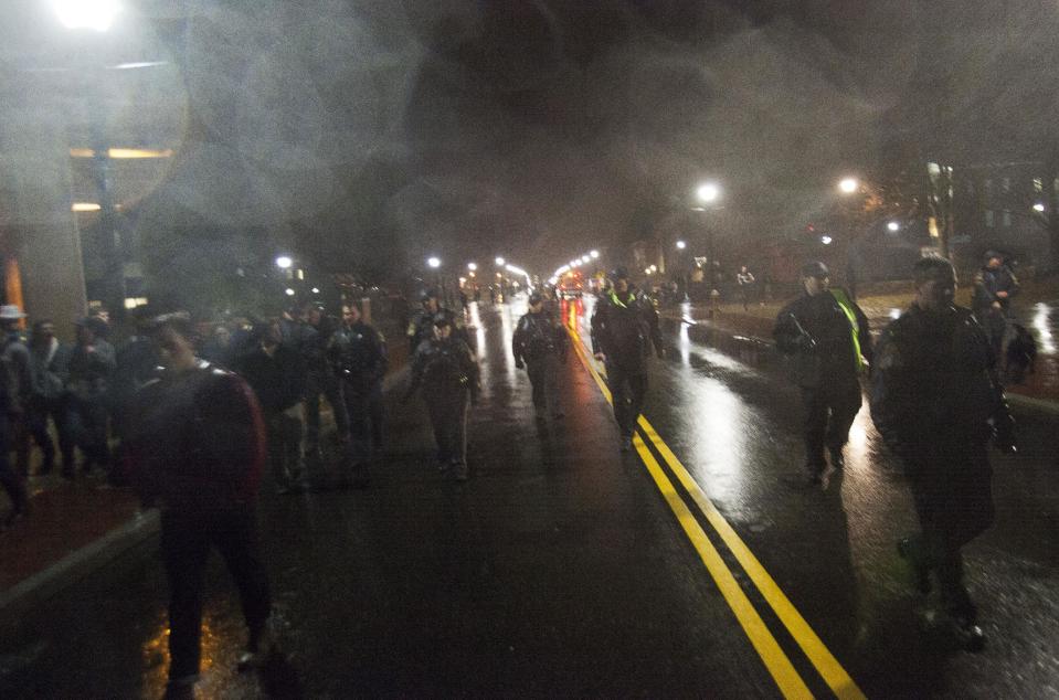 Police move students off the streets after the Connecticut Huskies defeated the Kentucky Wildcats in the men's final NCAA Final Four college basketball championship game at the University of Connecticut in Storrs, Connecticut April 8, 2014. Connecticut's experience trumped Kentucky's youth as the Huskies prevailed with a 60-54 NCAA national championship victory on Monday that completed a turnaround for the recently penalized program. REUTERS/Michelle McLoughlin (UNITED STATES - Tags: SPORT BASKETBALL)