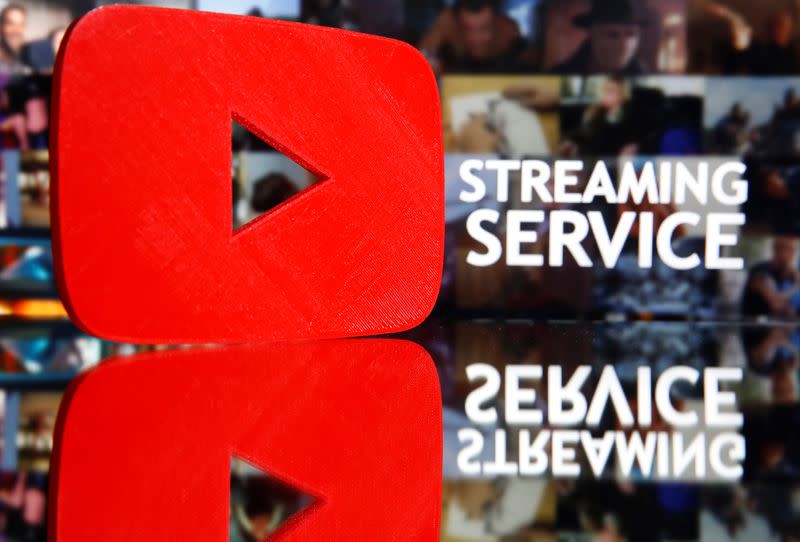 A 3D-printed Youtube logo is seen in front of displayed "Streaming service" words in this illustration