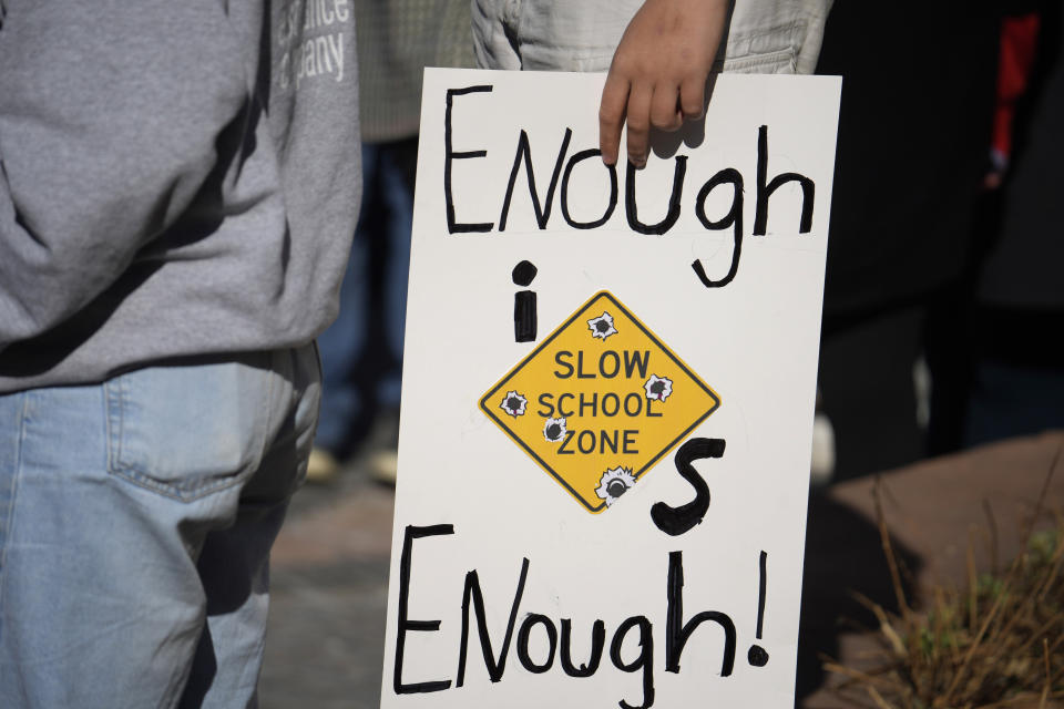 A student from East High School displays a sign to call for gun control measures to be considered by state lawmakers Thursday, March 23, 2023, during a rally outside the State Capitol in Denver. A shooting left two administrators injured at East High School on Wednesday, one of a series of gun-related events at the school in the past six weeks. (AP Photo/David Zalubowski)