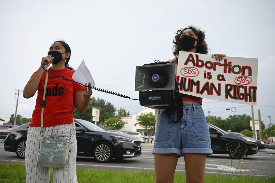 Chrisley Carpio and Victoria Hinckley, 20 speak to protesters during an abortion rights rally on Saturday, June 25, 2022 in Temple Terrace, Fla. A Florida judge on Thursday, June 30, said he would temporarily block a 15-week abortion ban from taking effect, following a court challenge by reproductive health providers who say the state constitution guarantees a right to the procedure. (Jefferee Woo/Tampa Bay Times via AP)