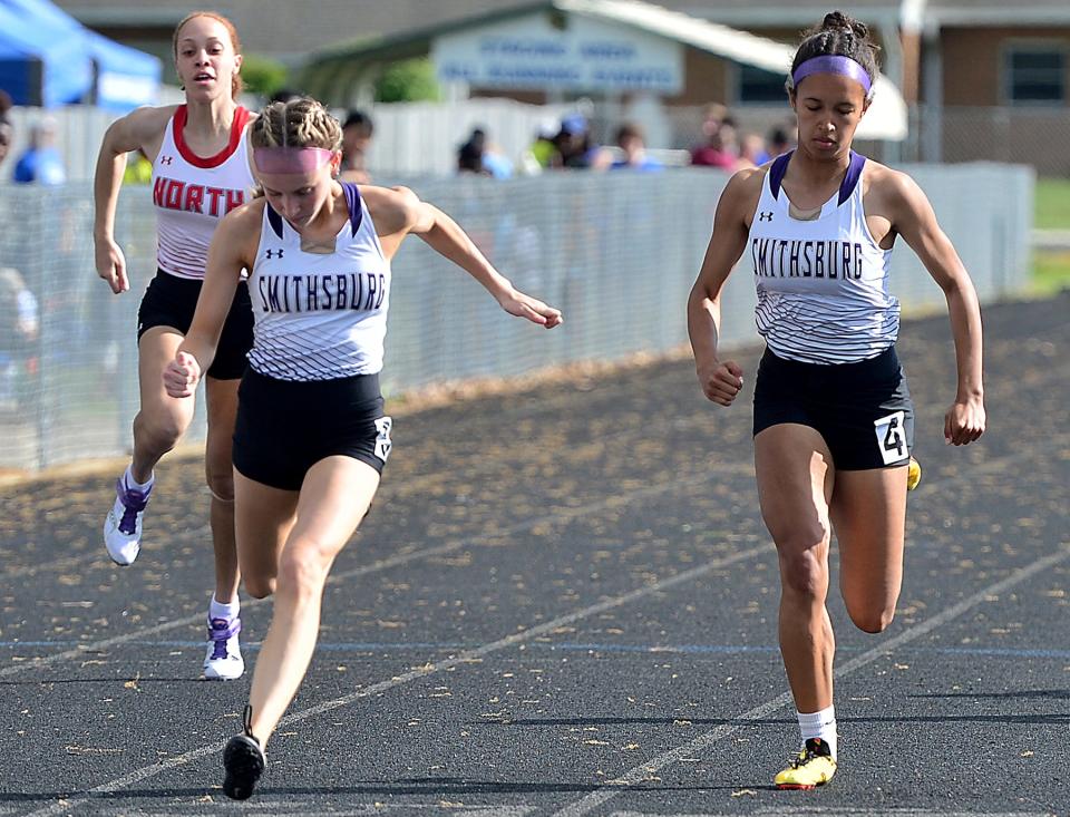 Smithsburg's Lexi Zimmerman, center, wins the girls 100-meter dash during the Washington County Track & Field Championships at Boonsboro. Smithsburg's Alaina Pate, right, finishes second.