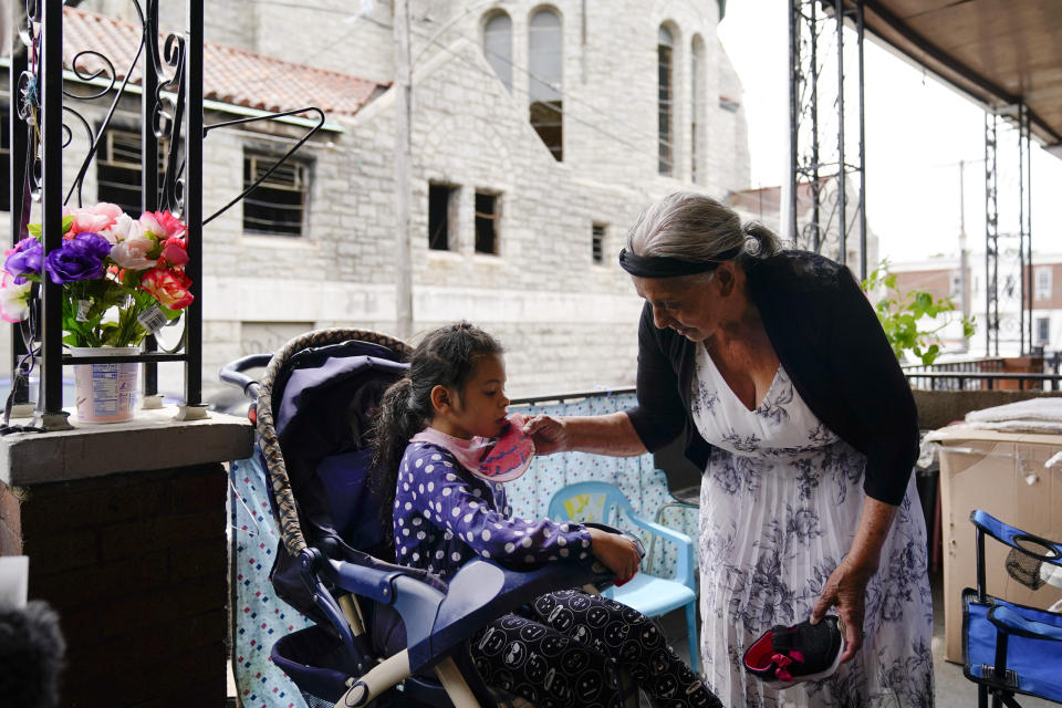 Amanda Brebe, 75, tends to her granddaughter Zuniga Gonzales, 7, in the Kensington section of Philadelphia, Sunday, May 16, 2021. (AP Photo/Matt Rourke)