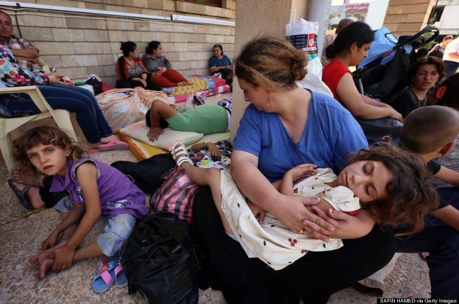 Iraqi Christians who fled the violence in the village of Qaraqush rest upon their arrival at the Saint-Joseph church in Arbil on August 7, 2014. (SAFIN HAMED/AFP/Getty Images) 