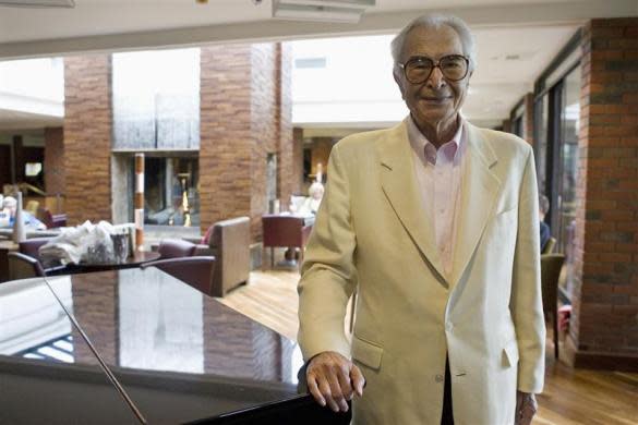 Dave Brubeck stands next to a piano in Monterey