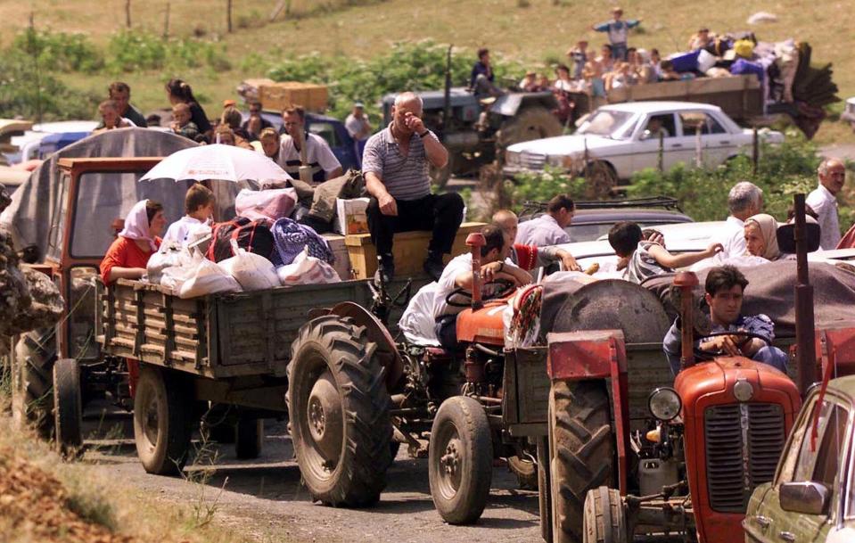 Thousands of refugees, backed up for miles, make their way into Kosovo near the border crossing at Morini, Albania, on June 16, 1999, despite warnings of minefields and little food in their Kosovo homeland.