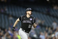 Colorado Rockies' C.J. Cron rounds the bases after hitting a solo home run on a pitch from Seattle Mariners starting pitcher Chris Flexen during the seventh inning of a baseball game, Tuesday, June 22, 2021, in Seattle. (AP Photo/John Froschauer)