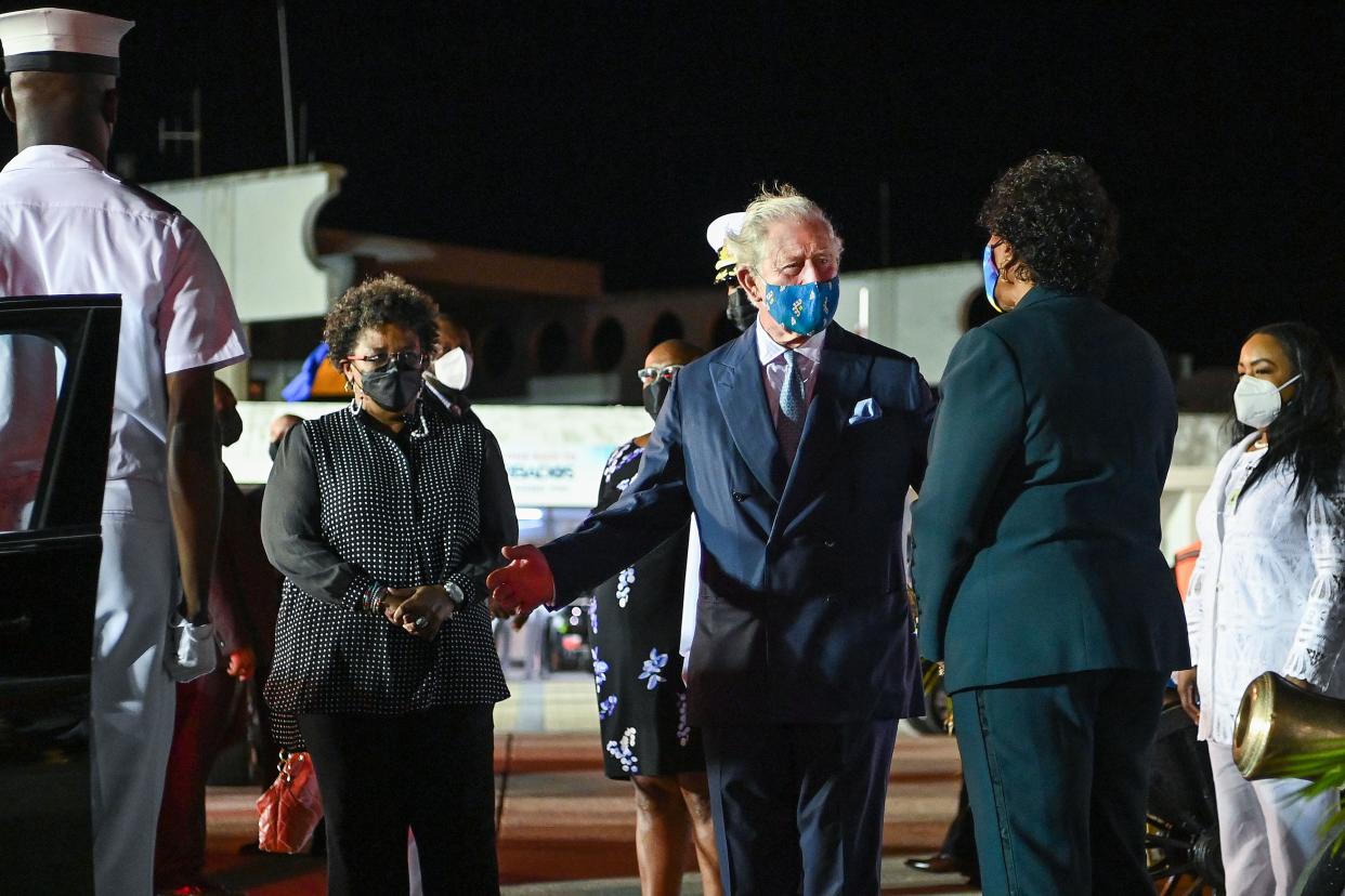 Prince Charles, Prince of Wales is greeted by Dame Sandra Mason as he arrives at Bridgetown Airport on November 28, 2021 in Bridgetown, Barbados.