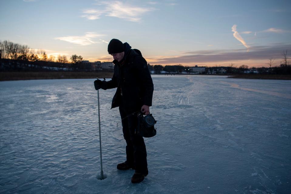 Jaykob Dilsaver of Marshall punctures a hole in the ice for ice fishing on Spring Lakes at Kellogg Community College on Tuesday, Jan. 11, 2022.