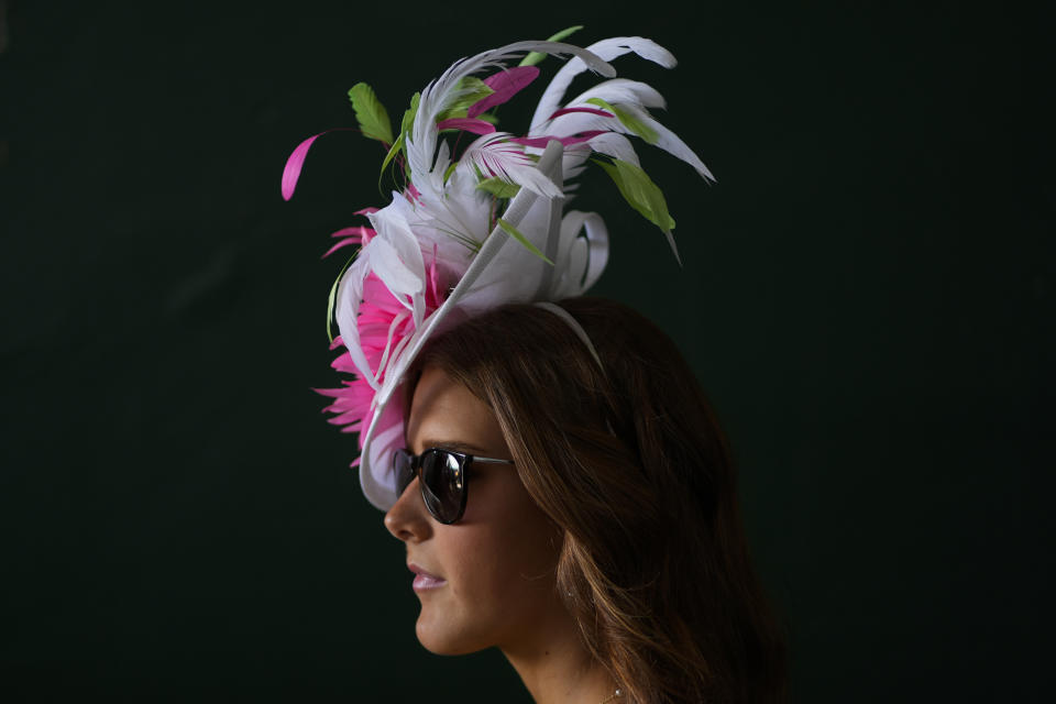 A race fan walks through the grounds of Churchill Downs before the 150th running of the Kentucky Derby horse race Saturday, May 4, 2024, in Louisville, Ky. (AP Photo/Charlie Riedel)