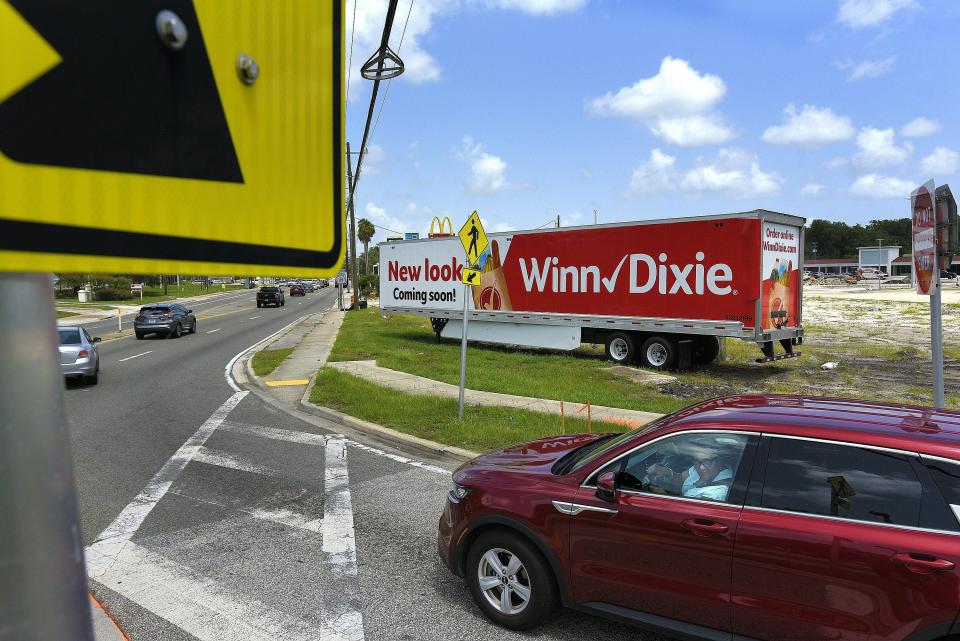 A trailer at the intersection of University Boulevard and an Arlington Expressway off-ramp displays a message that a new Winn-Dixie store is coming to the College Park shopping center. Southeastern Grocers, the current owner of the Winn-Dixie chain, says the work on the store isn't affected by the pending sale of Winn-Dixie to Aldi. The renovation of the shopping center is part of the city's Renew Arlington initiative.