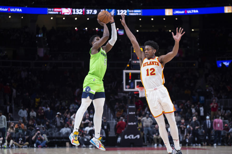 Minnesota Timberwolves guard Malik Beasley (5) shoots over Atlanta Hawks forward De'Andre Hunter (12) during the second half of an NBA basketball game Wednesday, Jan. 19, 2022, in Atlanta. (AP Photo/Hakim Wright Sr.)