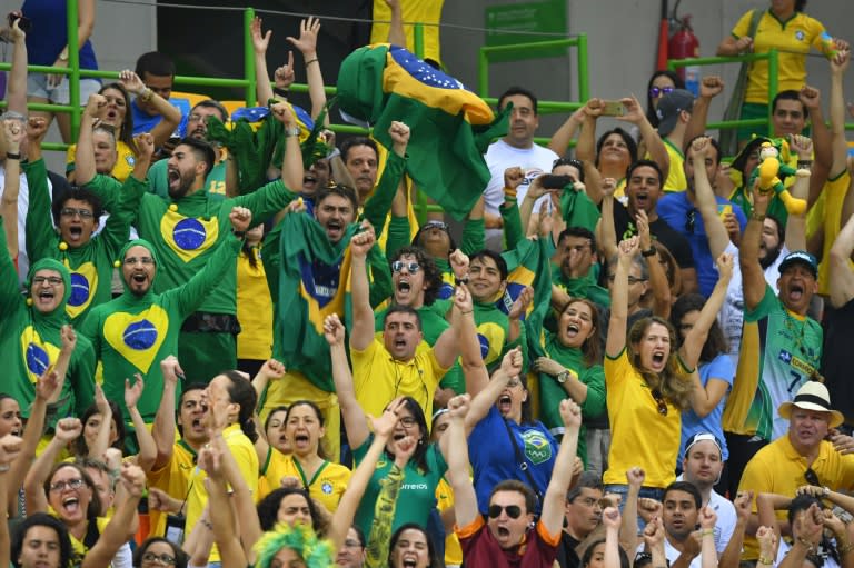 Brazilian fans cheer during the women's preliminaries handball match Norway vs Brazil for the Rio Olympics Games on August 6, 2016