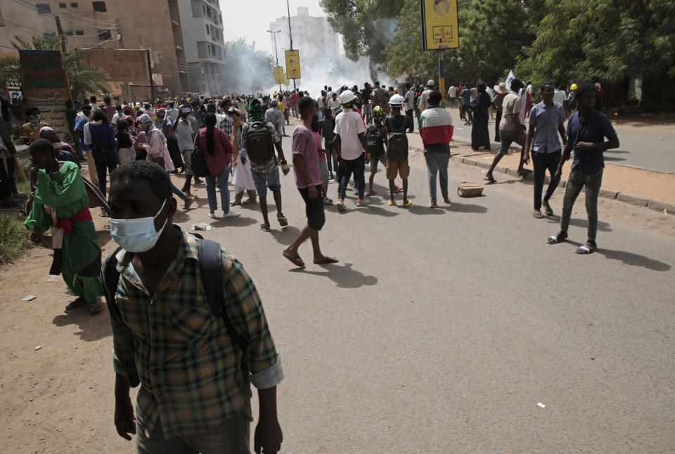 Protesters clash with security forces as they fire teargas to prevent them from marching towards the presidential palace during demonstrations demanding civilian rule, in Khartoum, Sudan, Thursday, May 19, 2022. (AP Photo/Marwan Ali)