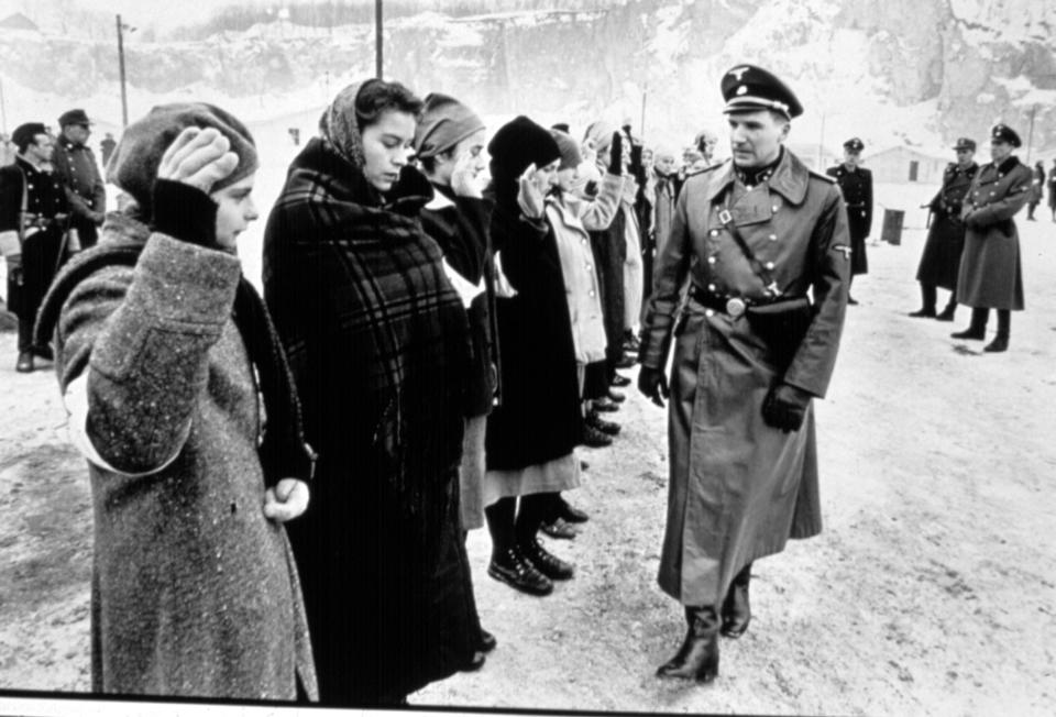 A nazi walks down a line of people