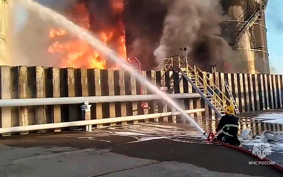 Firefighters tackle the blaze at the site of an oil reservoir in the Azov district of Russia.