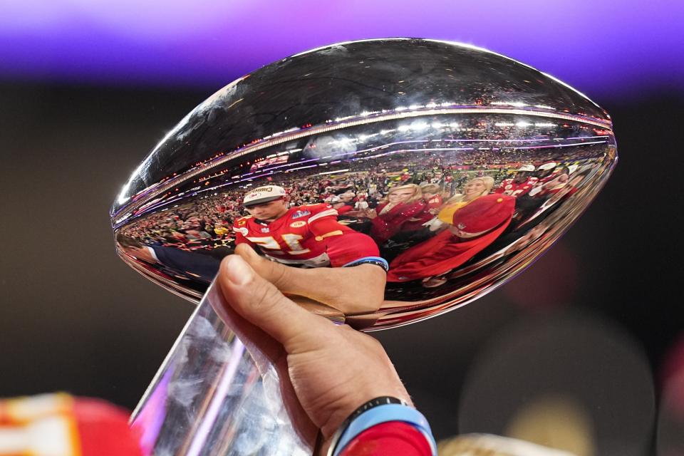 Kansas City Chiefs quarterback Patrick Mahomes is reflected in the Vince Lombardi Trophy after the NFL Super Bowl 58 football game against the San Francisco 49ers, Sunday, Feb. 11, 2024, in Las Vegas. The Chiefs won 25-22 against the 49ers. (AP Photo/Eric Gay)