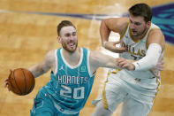 Charlotte Hornets forward Gordon Hayward drives around Dallas Mavericks guard Luka Doncic during the first half of an NBA basketball game in Charlotte, N.C., Wednesday, Jan. 13, 2021. (AP Photo/Chris Carlson)