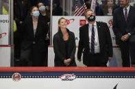 Kacey Bellamy, center, smiles as she is honored in a ceremony before a women's hockey game against Canada in a pre-Olympic Games series Monday, Oct. 25, 2021, in Hartford, Conn. (AP Photo/Jessica Hill)