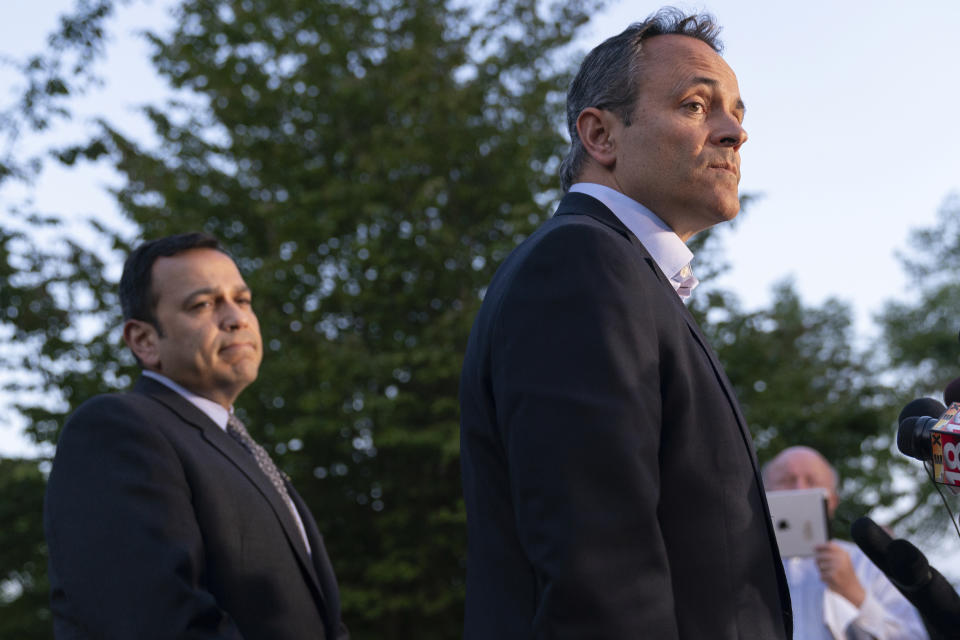 Kentucky Gov. Matt Bevin, right, with Kentucky Senator Ralph Alvarado, the republican nominee for lieutenant governor, listens as he speaks to the media after winning the republican gubernatorial primary, in Frankfort, Ky., Tuesday, May 21, 2019. (AP Photo/Bryan Woolston)