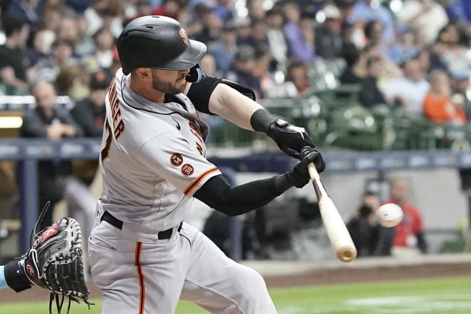 San Francisco Giants' J.D. Davis hits a two-run scoring double during the third inning of a baseball game against the Milwaukee Brewers Friday, May 26, 2023, in Milwaukee. (AP Photo/Morry Gash)