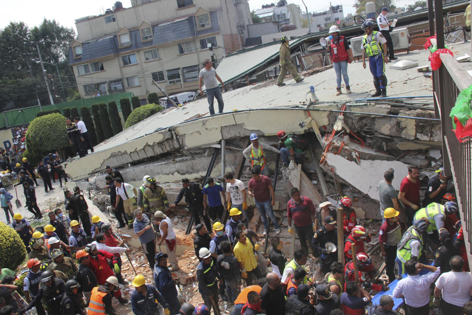 <em>Rescue workers found the child alive in the rubble of the Enrique Rebsamen primary school (AP)</em>