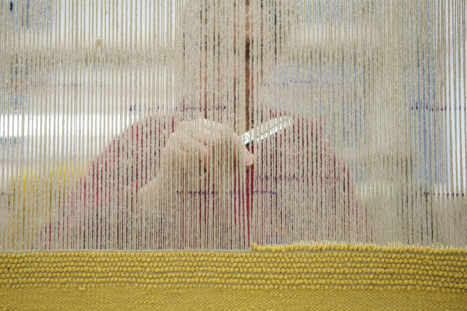 A craftswoman weaves a tapestry at the Royal Tapestry Factory in Madrid, Spain, Friday, Nov. 30, 2023. Since its foundation in 1721, the Royal Tapestry Factory of Madrid has not stopped producing. It was Philip V, then King of Spain, who had the factory built with the help of Catholic craftsmen from Flanders to replace the lack of private initiative that existed at the time. (AP Photo/Manu Fernandez)