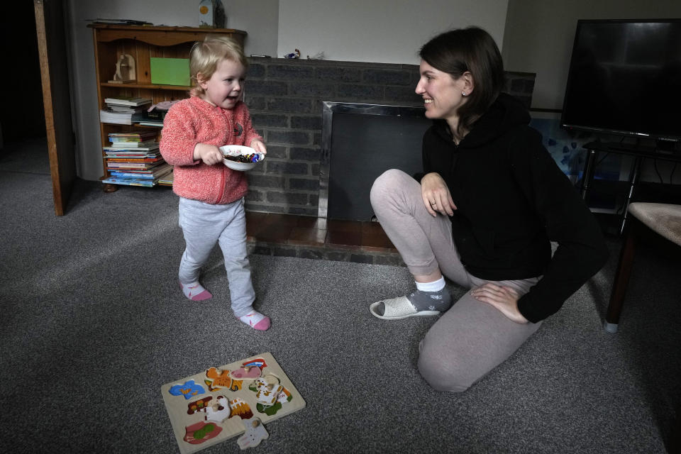 Viktoria Kovalenko and her daughter Varvara at their home in a village in Kent, Thursday, Feb. 9, 2023. Viktoria, 34, and her daughter Varvara are trying to settle in Britain after fleeing the war in Ukraine, where she lost her husband and 12-year-old daughter during a Russian military attack. The family have found housing through a charity, but they long to return to their own home in Ukraine. (AP Photo/Frank Augstein)