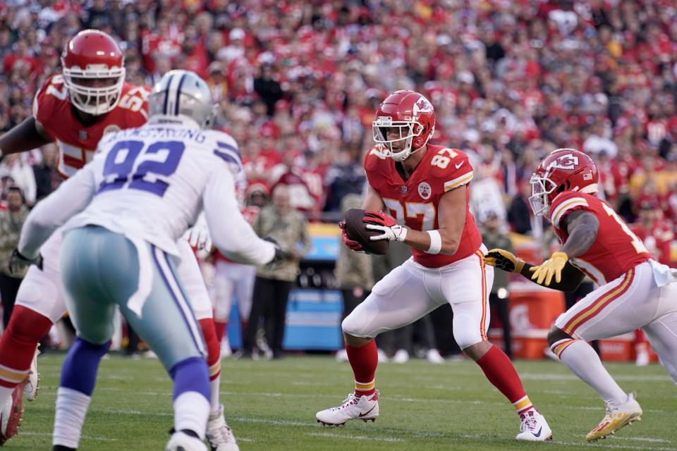 Kansas City Chiefs tight end Travis Kelce (87) takes the snap before running the ball in for a touchdown during the first half of an NFL football game against the Dallas Cowboys Sunday, Nov. 21, 2021, in Kansas City, Mo. (AP Photo/Charlie Riedel)