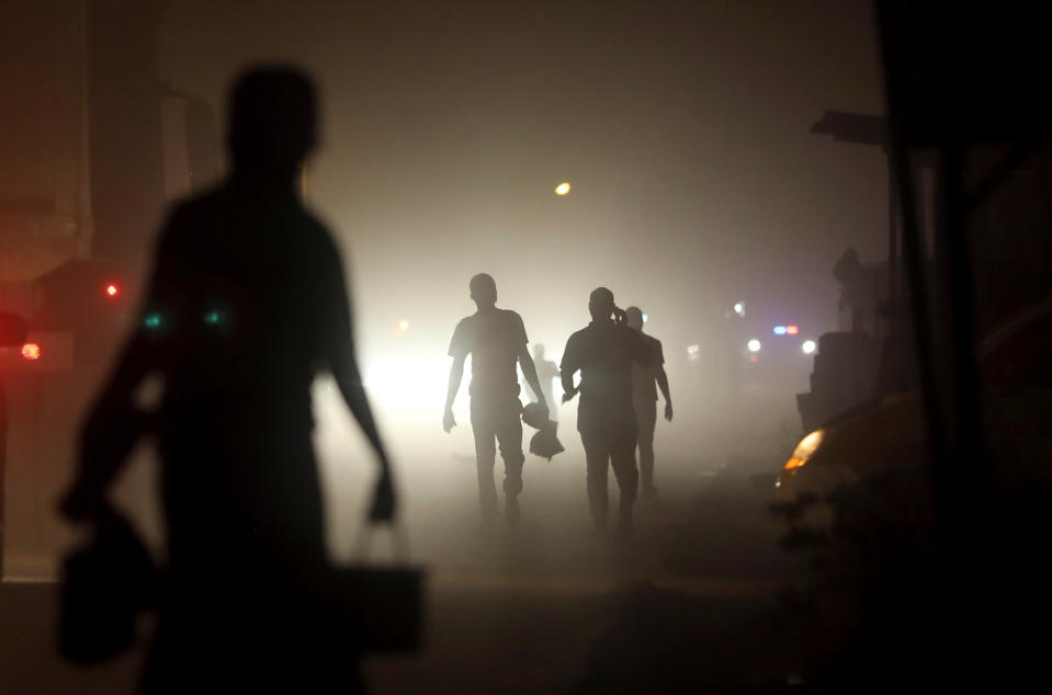 Locals walk on a street in Tarkwa, Ghana. (Photo: Siphiwe Sibeko/Reuters)