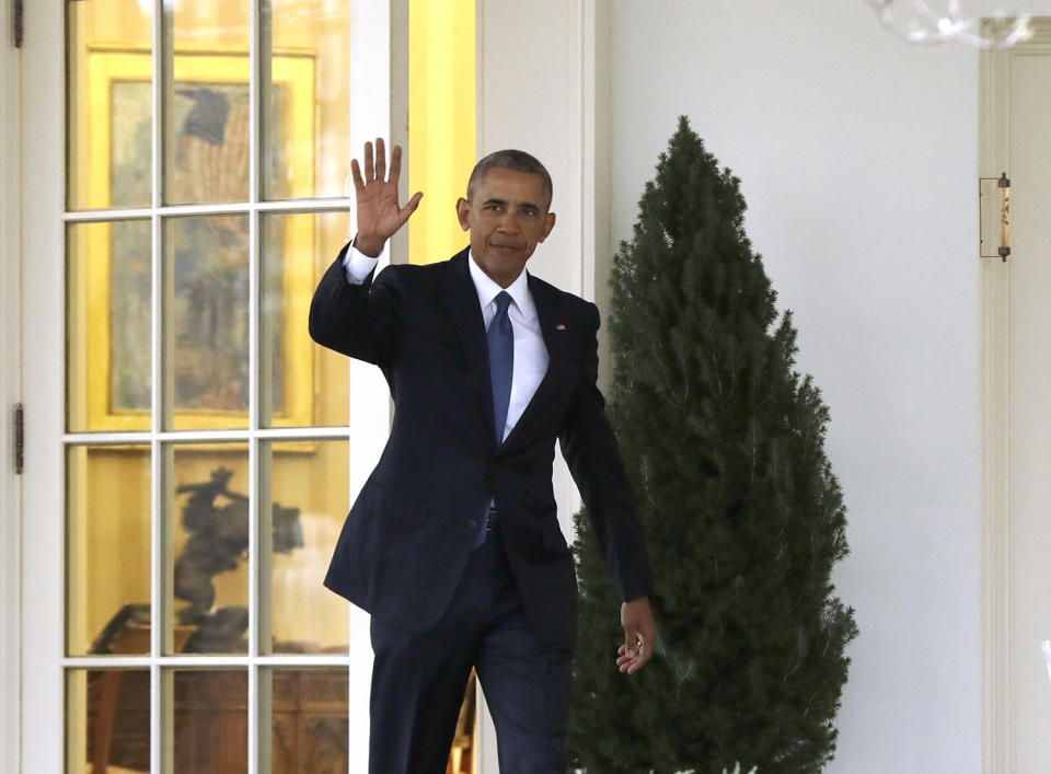 Obama waves as he leaves the Oval Office