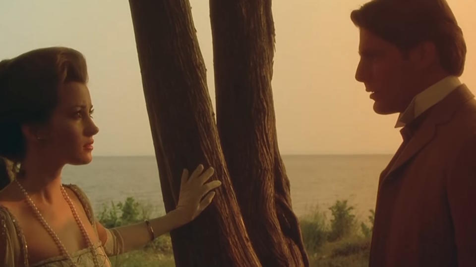 Jane Seymour and Christopher Reeve stand in the sunset in Somewhere in Time