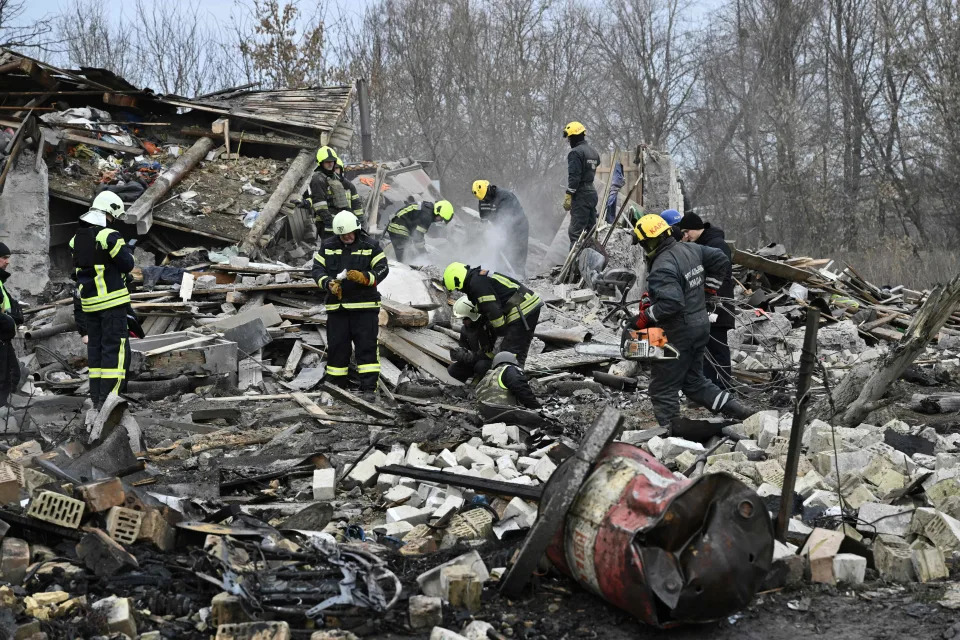 Rescuers clear debris of homes destroyed by a missile attack in the outskirts of Kyiv.