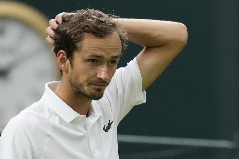 FILE - Russia's Daniil Medvedev reacts during the men's singles fourth round match against Poland's Hubert Hurkacz on day eight of the Wimbledon Tennis Championships in London, Tuesday, July 6, 2021. The ATP men’s professional tennis tour will not award ranking points for Wimbledon this year because of the All England Club’s ban on players from Russia and Belarus over the invasion of Ukraine. The ATP announced its decision Friday night, May 20, 2022, two days before the start of the French Open — and a little more than a month before play begins at Wimbledon on June 27. It is a highly unusual and significant rebuke of the oldest Grand Slam tournament. (AP Photo/Kirsty Wigglesworth, File)