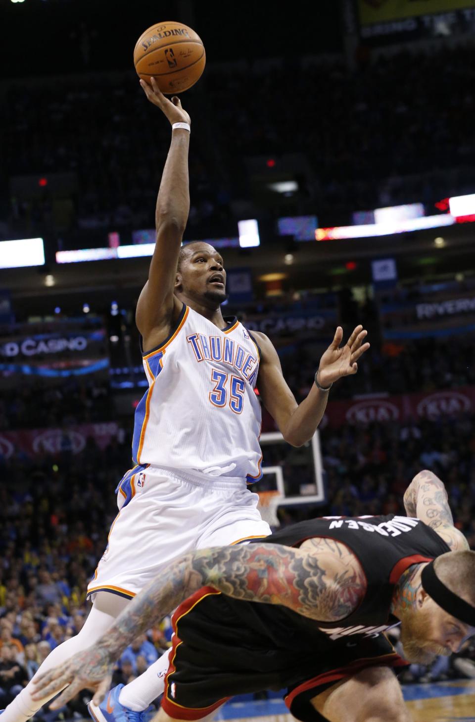 Oklahoma City Thunder's Kevin Durant (35) shoots over Miami Heat forward Chris Andersen (11) following a foul by Andersen during the third quarter of an NBA basketball game in Oklahoma City, Thursday, Feb. 20, 2014. Miami won 103-81. (AP Photo/Sue Ogrocki)