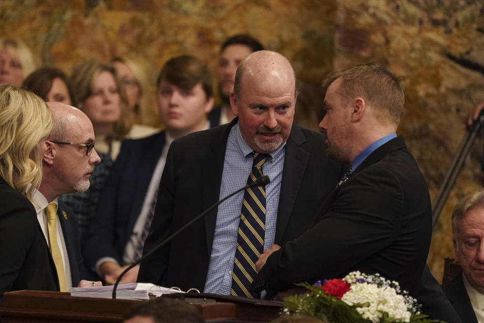 Rep. Matt Bradford, D-Montgomery, center, talks to Republican Rep. Bryan Cutler, right, as legislators of the Pennsylvania House of Representatives are sworn-in, Tuesday, Jan. 3, 2023, at the state Capitol in Harrisburg, Pa. The ceremony marks the convening of the 2023-2024 legislative session of the General Assembly of Pennsylvania. (AP Photo/Matt Smith)