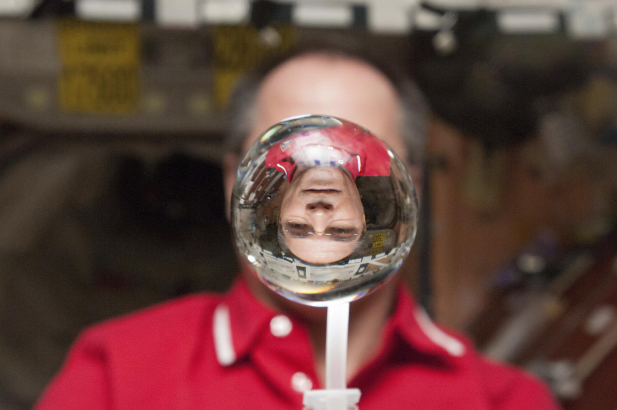 NASA astronaut Kevin Ford, Expedition 34 commander, watches a water bubble float freely between him and the camera on the International Space Station in this NASA handout photo released January 30, 2013. REUTERS/NASA/Handout