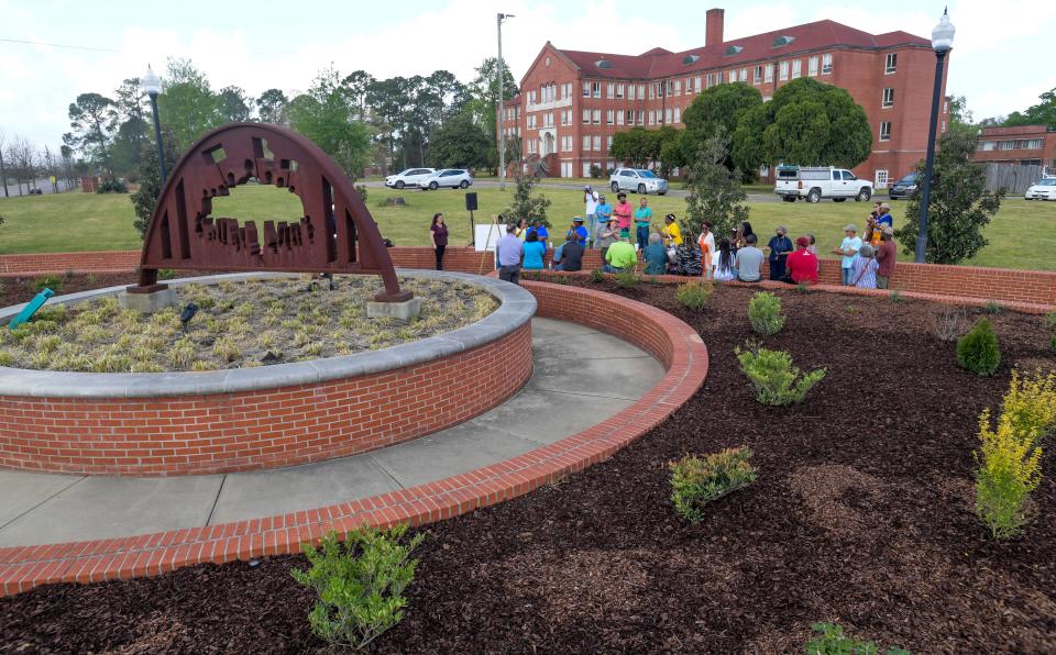 Residents celebrate the expanded garden at Oak Street and Fairview Avenue in Montgomery, Alabama, on Saturday, March 25, 2023.