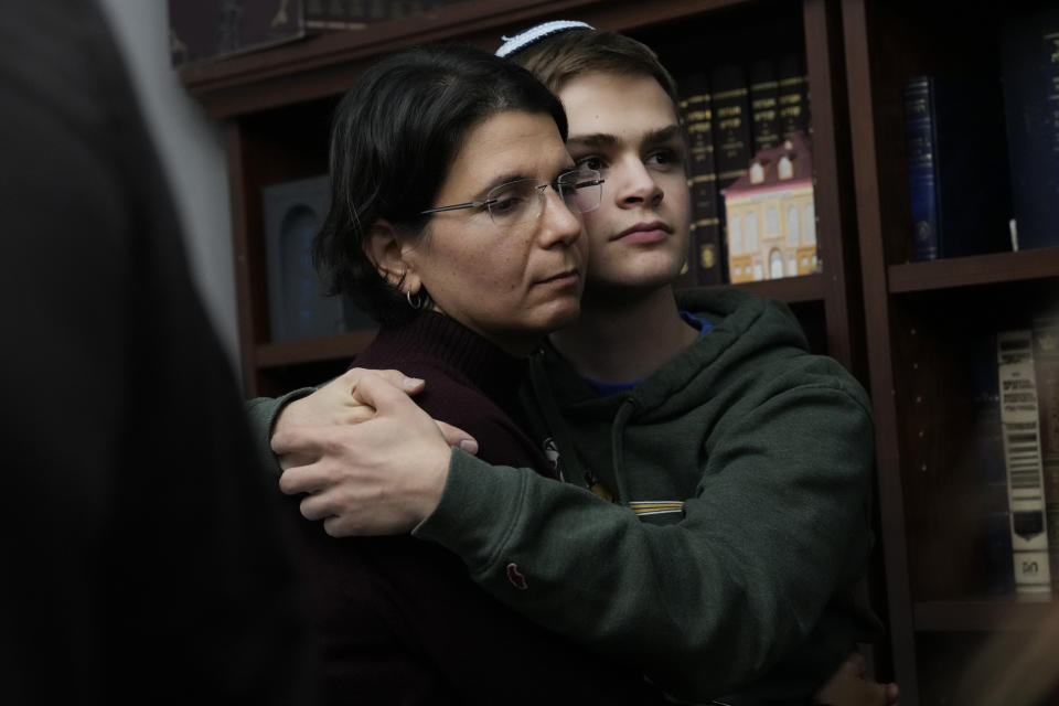 Asher King-Yariv, a member of the Chabad of Evanston, Ill, hugs his mother at the beginning of Shabbat Friday, Oct. 20, 2023, in Evanston. Judith Raanan, a member of Chabad, and her daughter Natalie were released Friday from their captivity in Gaza. (AP Photo/Charles Rex Arbogast)