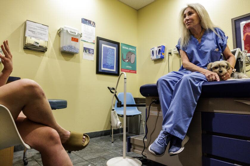 PHOENIX, AZ - APRIL 17, 2024: Dr. Barbara Zipkin consults with patient Anna, 24, about her options for an abortion at Camelback Family Planning on April 17, 2024 in Phoenix, Arizona. Anna had heard about the Arizona Supreme Court ruling reinstating an 1864 law banning abortion. "God this makes me so mad," she told her partner. Anna decided to take a pregnancy test and then made an appointment with the clinic before time would run out. Dr Zipkin is accompanied by her support dog Scooter.(Gina Ferazzi / Los Angeles Times)